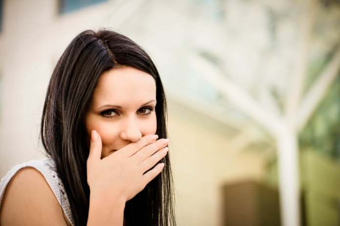 Girl Covering Her Mouth | Anesthetic Dentistry