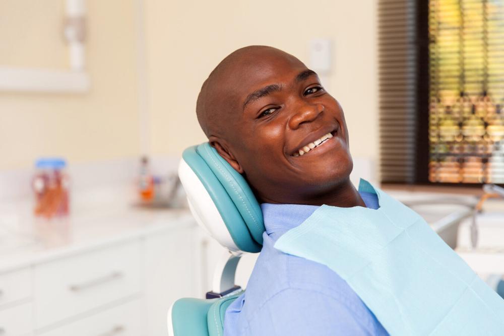 tooth-colored filling royal palm beach | man smiling in dental chair