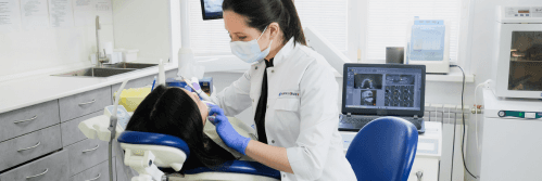 Dentist performing a procedure on a patient in a modern dental clinic.