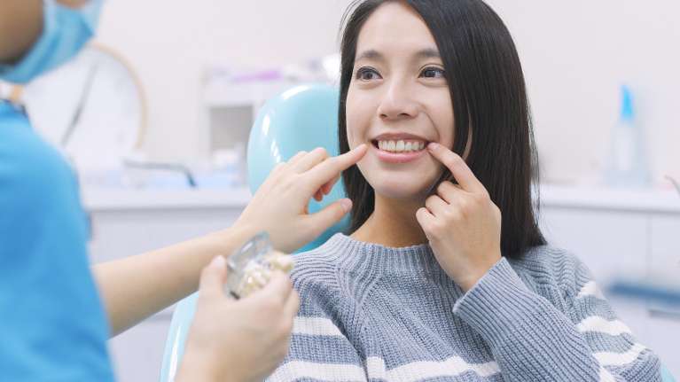 best dentist for tooth extraction | woman at dentist