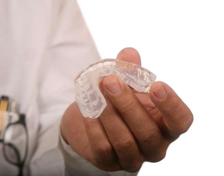 dentist holding CPAP alternative, which is oral appliance therapy